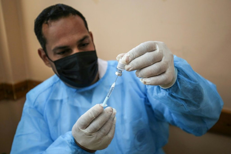 A UN relief worker in the Gaza Strip on March 3, 2021 prepares a dose of Russia's Sputnik V vaccine, which US intelligence has accused Moscow of seeking to promote through disinformation against US alternatives