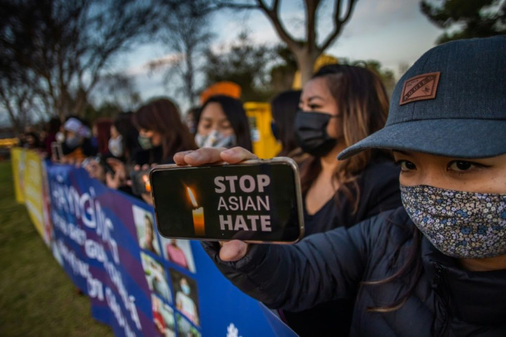 Julie Tran holds her phone during a candlelight vigil in California on March 17, 2021 to unite against violence targeting Asians after a shooting left eight people dead in Atlanta, Georgia, including at least six Asian women