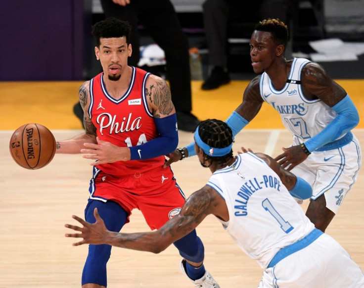 Philadelphia's Danny Green looks to pass as he is guarded by Dennis Schroder and Kentavious Caldwell-Pope