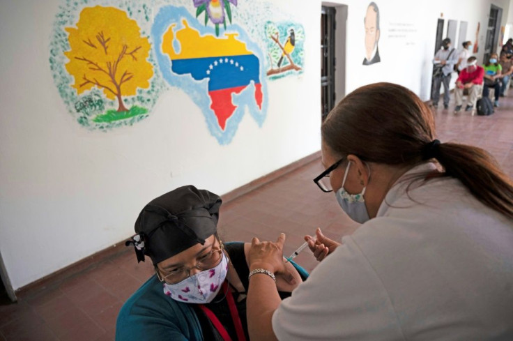 A teacher receives a dose of the Covid-19 vaccine developed by China's Sinopharm at a vaccination center in the Venezuelan city of Catia on March 8, 2021