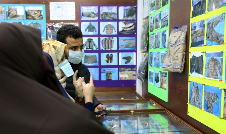 Libyans, shown in January, checking for news of loved ones check belongings of people found in mass graves around Tarhuna, at the forensic medicine department in Tripoli Medical Center