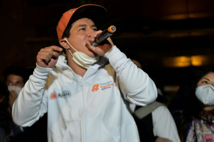 Andres Arauz, who plans to switch to clean energy instead of fossil fuels for generating electricity and for the public transport system, speaks during a campaign rally with rappers in Quito on April 1, 2021