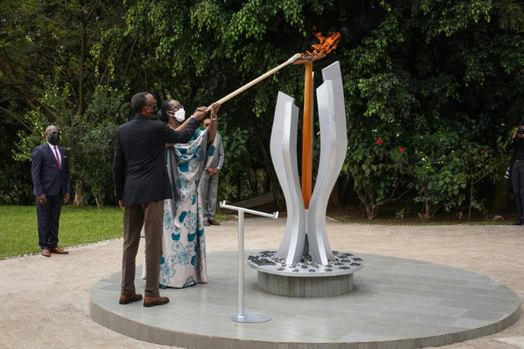 Rwandan President Paul Kagame and his wife Jeannette light a remembrance flame for victims of the genocide
