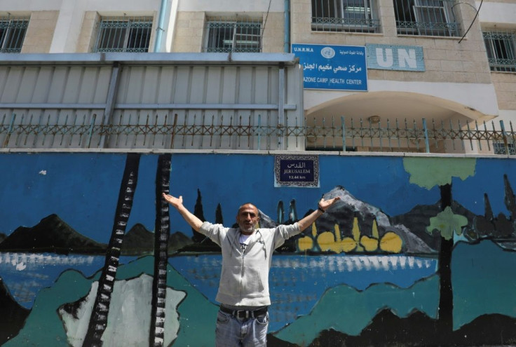 A Palestinian gestures outside a United Nations health  centre in the Palestinian refugee camp of Al-Jalazoun near Ramallah on the West Bank