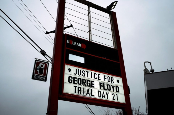 A sign at the 'George Floyd Square' memorial notes Day 21 of the Derek Chauvin murder trial