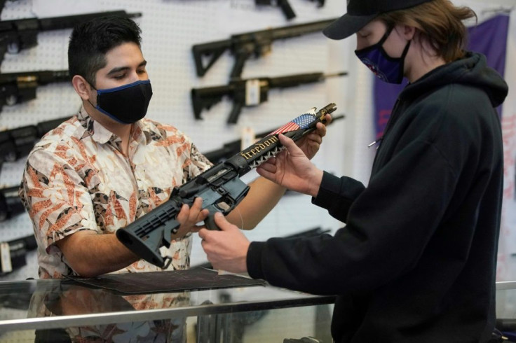A customer looks at a custom made AR-15 style rifle at a shop in Orem, Utah in February 2021