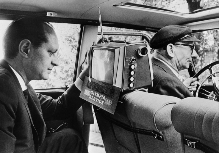 A taxi passenger watches the 1964 Tokyo  Olympics in Hamburg, Germany. Japanese tech transformed the Games  - AFP
