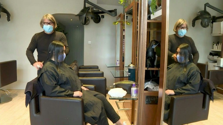 Britons toast a significant easing of coronavirus restrictions, with early morning pints -- and much-needed haircuts -- as the country took another tentative step towards the resumption of normal life.