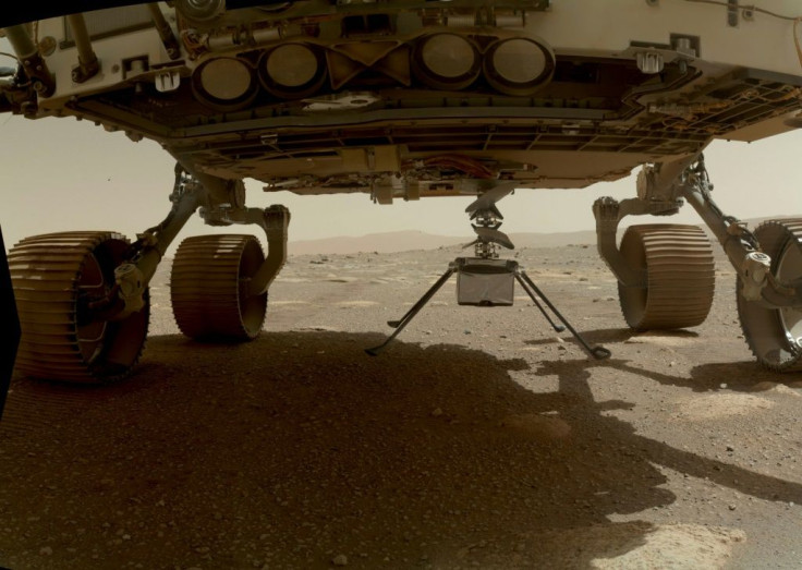 NASA's Ingenuity Mars Helicopter, with all four of its legs deployed, is pictured before dropping from the belly of the Perseverance rover in March 2021