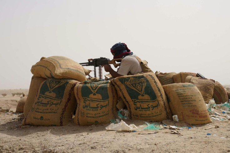 A fighter with forces loyal to Yemen's Saudi-backed government holds a position against Huthi rebels in Yemen's northeastern province of Marib