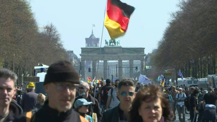 Several thousand protesters gather in central Berlin, waving flags and placards, as German lawmakers prepare to vote on a law amendment giving Angela Merkel's government power to impose tougher measures to curb the coronavirus pandemic.