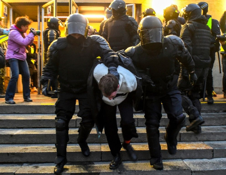 Police officers detain a protester during a rally in support of jailed Kremlin critic Alexei Navalny, in central Saint Petersburg