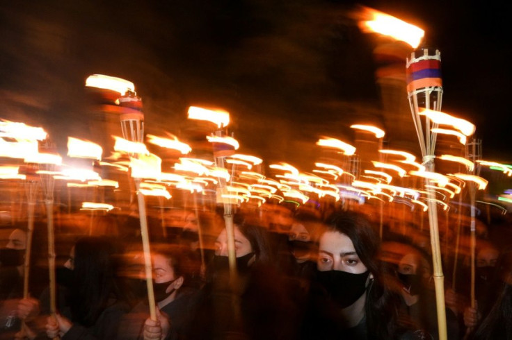 Armenians take part in a torchlight procession in Yerevan to mark the 106th anniversary of World War I-era mass killings