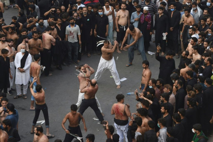 Dressed in black, devotees chanted slogans and slapped their chests in unison while others whipped themselves with blades at the Lahore procession