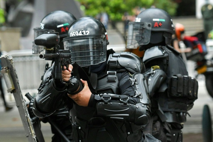 Riot police clash with demonstrators in Medellin, on April 28, 2021