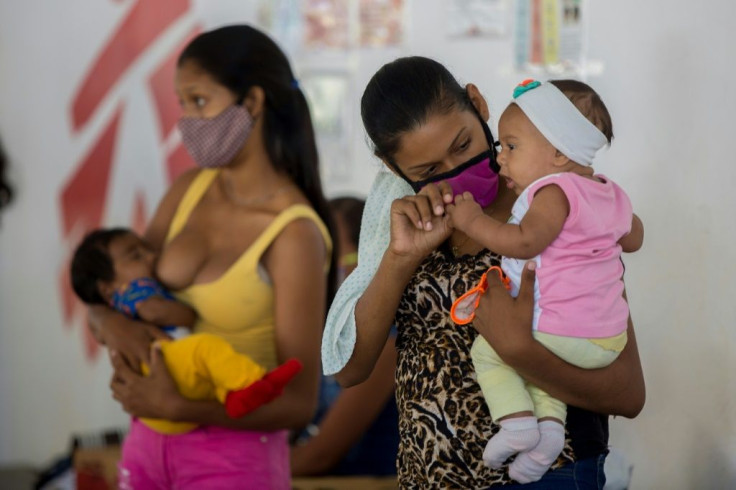 Teenager Deiglis waits with her baby to receive a contraceptive implant at an outpatient clinic set up by the Doctors Without Borders NGO