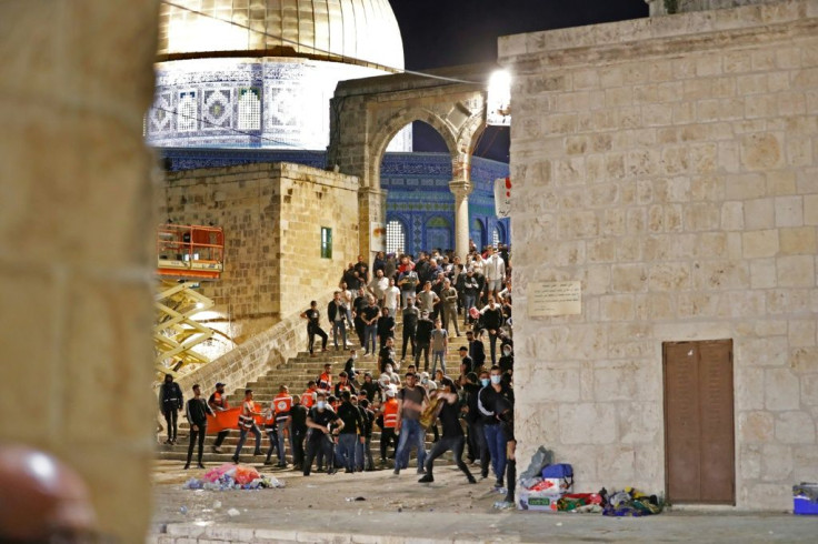 Palestinian protesters hurl stones during rare clashes with Israeli police at the Al-Aqsa mosque compound in Jerusalem, on May 7, 2021