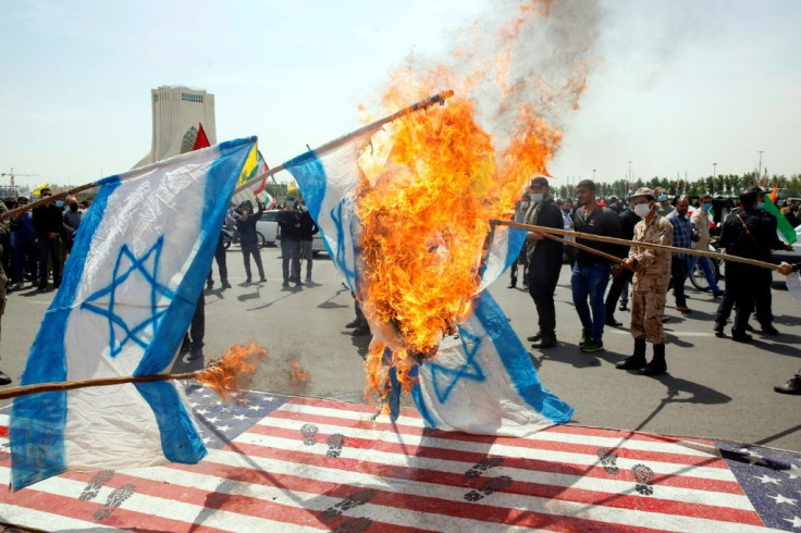 Iranians torch Israeli flags during a rally marking Al-Quds (Jerusalem) Day in Tehran
