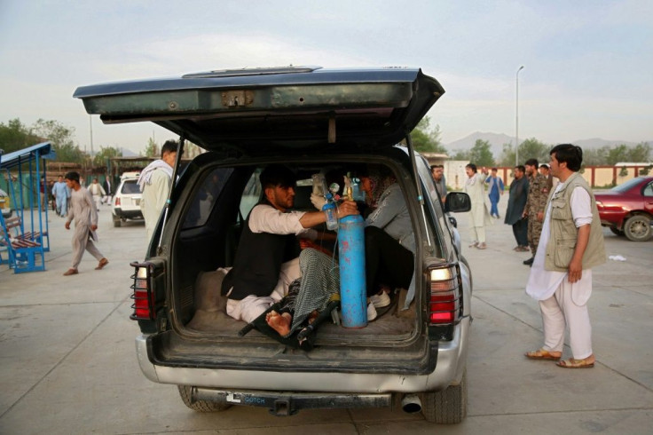 A wounded man is brought to hospital following the bomb attack. Afghan officials including President Ashraf Ghani blamed the Taliban although the insurgents denied responsibility