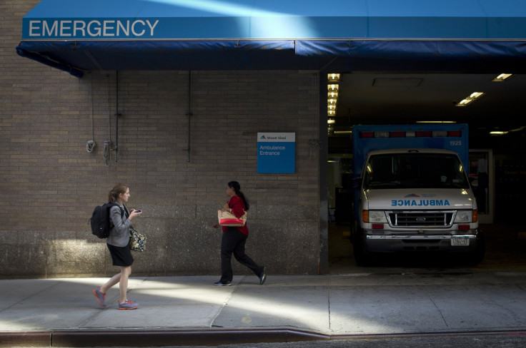 Two women walk past the emergency entrance of Mount Sinai Hospital in the Manhattan borough of New York on Aug. 4, 2014.