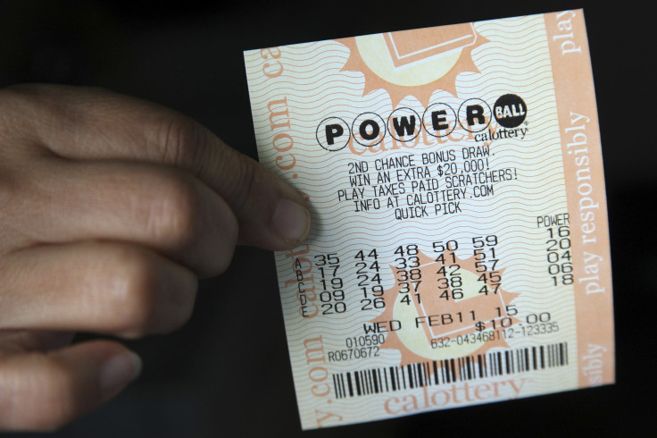 In this photo, a woman holds a ticket for the Powerball lottery jackpot of $450 million in Los Angeles on Feb. 9, 2015.
