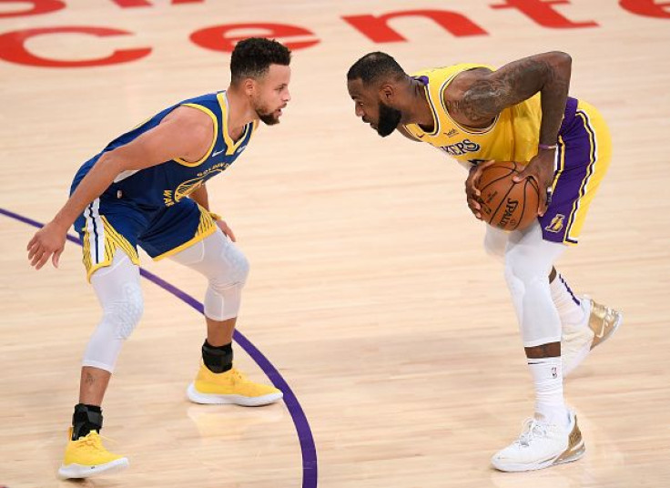 LOS ANGELES, CALIFORNIA - JANUARY 18: LeBron James #23 of the Los Angeles Lakers is guarded by Stephen Curry #30 of the Golden State Warriors during the first half at Staples Center on January 18, 2021 in Los Angeles, California.