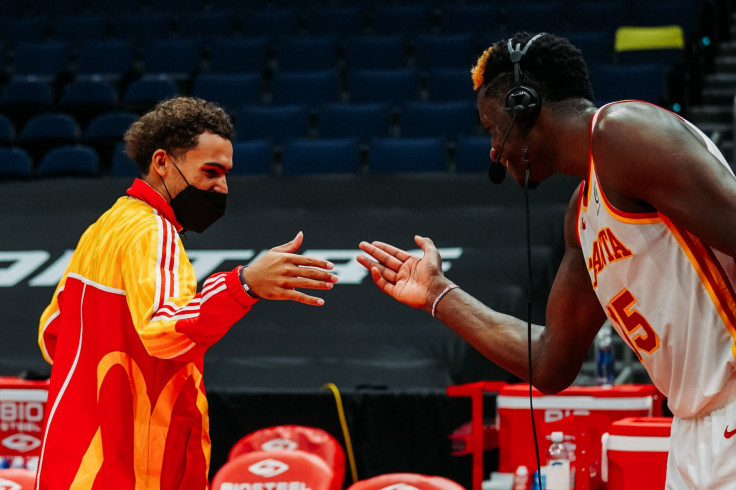 Atlanta Hawks all-star Trae Young (L) high-fives Clint Capela (R) during one of their wins in the 2020-2021 NBA season.