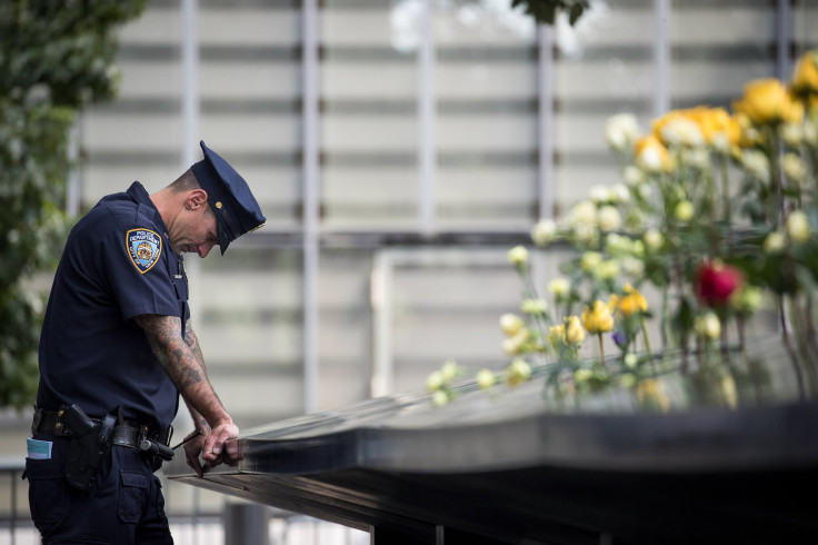 An New York City Police Department officer is accused of assaulting a man over a spilled drink. In this photo, a New York City Police Department (NYPD) officer pauses while visiting the North pool during a commemoration ceremony for the victims of the Sep