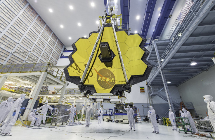 NASA technicians lift the James Webb Space Telescope using a crane to move it inside a clean room at NASA's Goddard Space Flight Center in Greenbelt, Maryland.