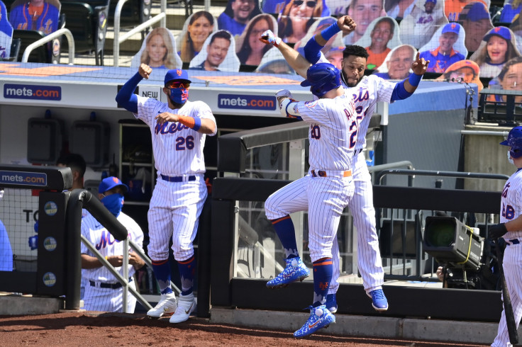 Pete Alonso #20 of the New York Mets is congratulated by his teammate Robinson Cano #24 after hitting a solo home run against the Philadelphia Phillies during the second inning at Citi Field on September 06, 2020 in New York City. 