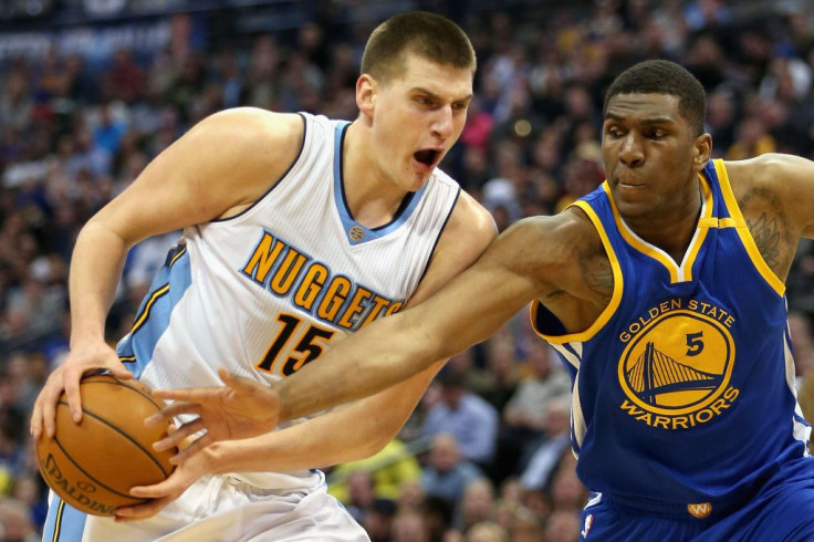 Nikola Jokic #15 of the Denver Nuggets drives to the basket against Kevon Looney #5 of the Golden State Warriors at the Pepsi Center on February 13, 2017 in Denver, Colorado.