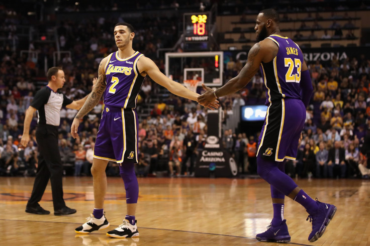 Lonzo Ball #2 and LeBron James #23 of the Los Angeles Lakers high five during the first half of the NBA game against the Phoenix Suns at Talking Stick Resort Arena in Phoenix, Arizona, Oct. 24, 2018. 