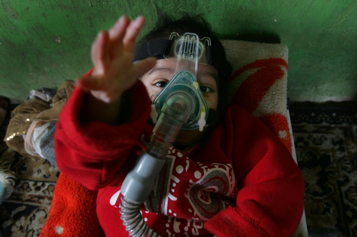 A child breathes with the aid of a CPAP breathing pump in the unrecognized Bedouin Arab village of Umbatin in Israel's Negev desert, March 29, 2007. 