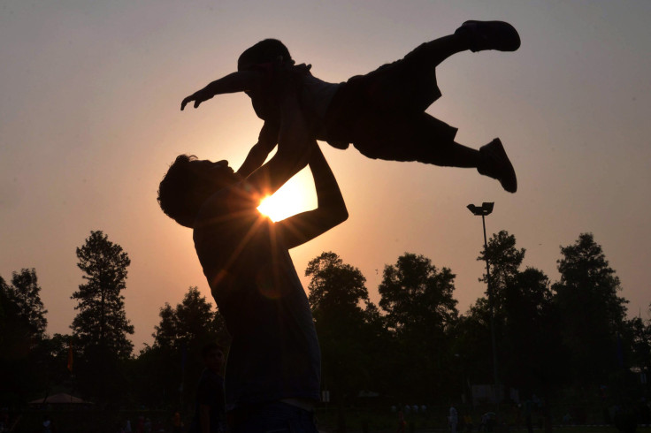 Indian father Shailesh, pictured June 19, 2016 throwing up his son at a park on Father's Day, Father's Day is celebrated in several countries worldwide.