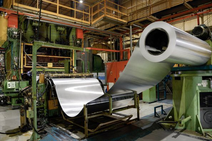 Aluminum prices rallied, bringing some holiday cheer to Australian miners BHP Billiton and Rio Tinto. Pictured: A roll of sheet aluminium is fed into a press at the Rexam Beverage can plant in Jacarei, Brazil, Nov. 5, 2015.