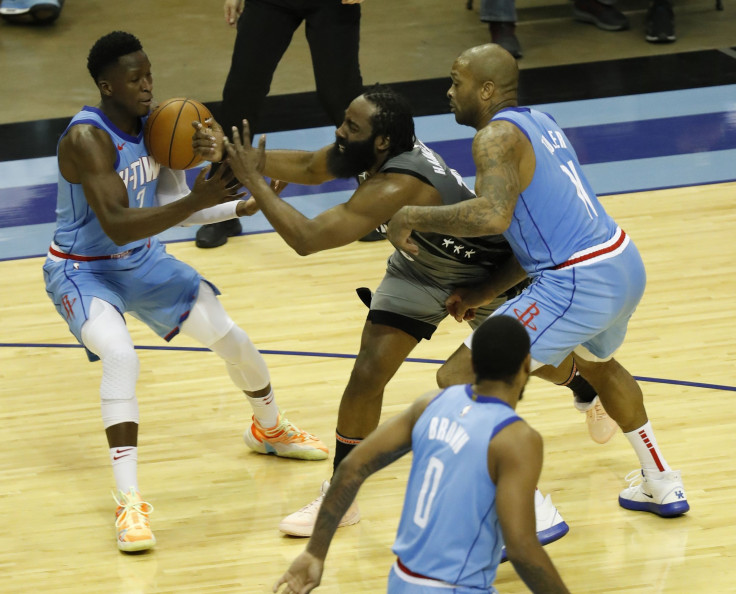 James Harden #13 of the Brooklyn Nets loses the ball as he is pressured by P.J. Tucker #17 of the Houston Rockets and Victor Oladipo #7 