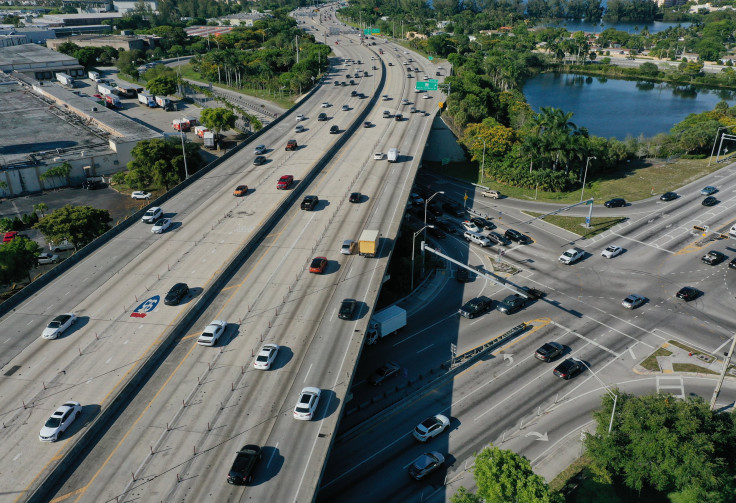  In an aerial view, vehicles drive along Interstate 95 near the intersection to Miami Gardens Drive on May 27, 2021 in Miami, Florida. 