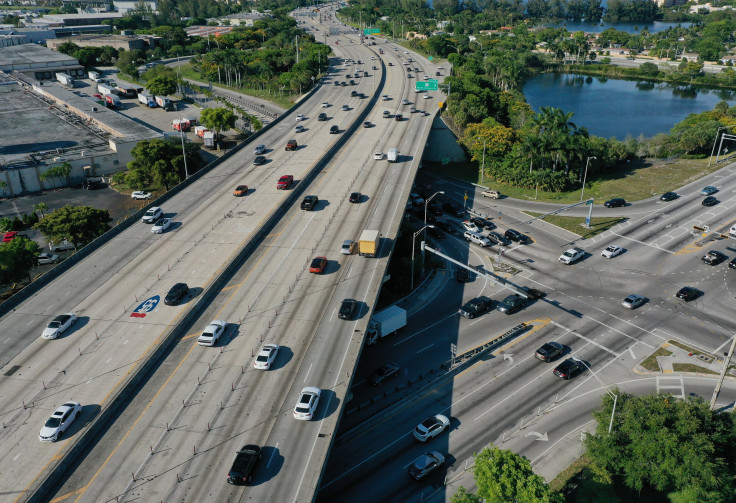 In an aerial view, vehicles drive along Interstate 95 near the intersection to Miami Gardens Drive on May 27, 2021 in Miami, Florida.