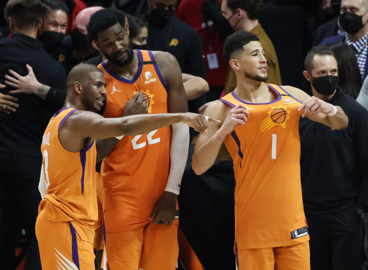 JUNE 30: Devin Booker #1 of the Phoenix Suns celebrates with teammates Deandre Ayton #22 and Chris Paul #3 following the team's series win against the LA Clippers in Game Six of the Western Conference Finals at Staples Center on June 30, 2021 in Los Angel