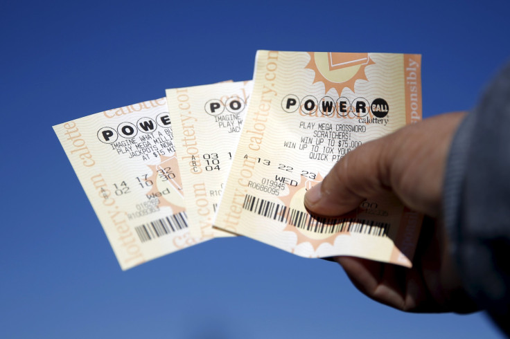 A woman holds Powerball lottery tickets outside Bluebird Liquor in Hawthorne, California, on Jan. 12, 2016.