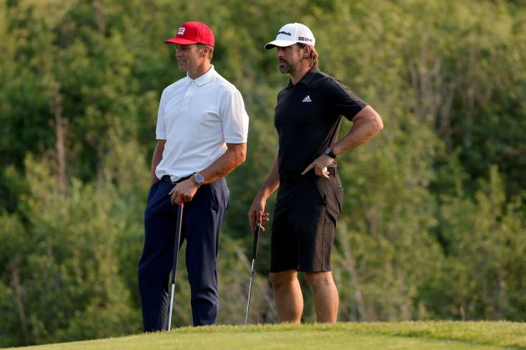 Tom Brady (L) and Aaron Rodgers meet during Capital One's The Match at The Reserve at Moonlight Basin on July 06, 2021 in Big Sky, Montana.