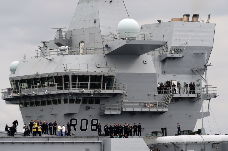 Crew stand on the decks of the 65,000-tonne British aircraft carrier HMS Queen Elizabeth on the Firth of Forth in east Scotland, June 26, 2016.