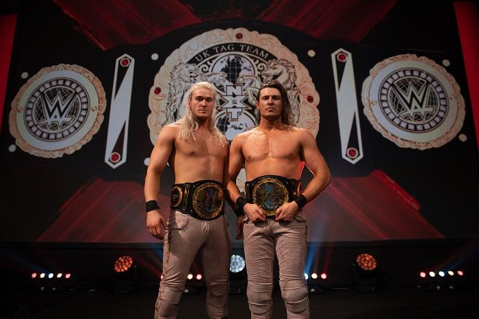 NXT UK Tag Team Champions Pretty Deadly poses with their newly won titles.