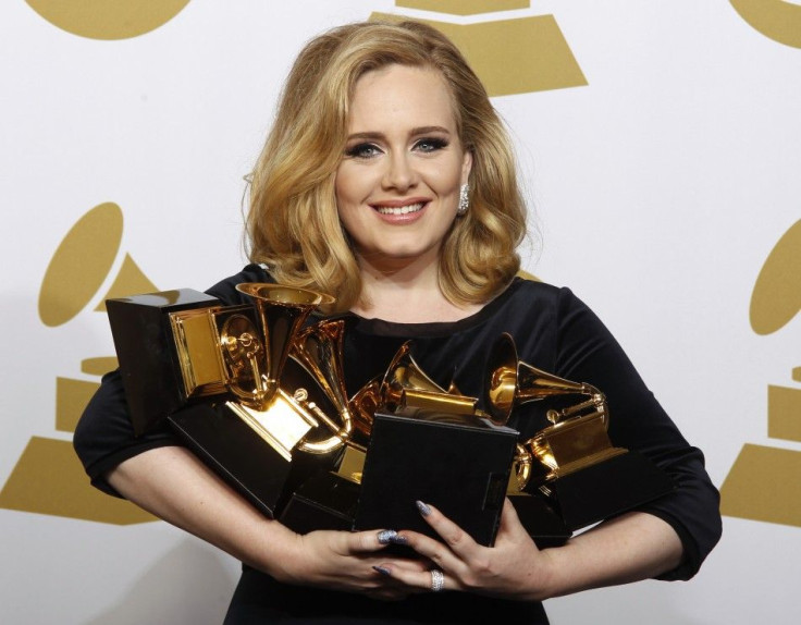 Singer Adele holds her six Grammy Awards at the 54th annual Grammy Awards in Los Angeles, Calif. The UK's The Sun has reported that the singer will be taking a break to focus on making her relationship work with boyfriend Simon Konecki.