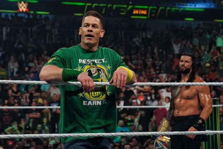 John Cena (foreground) makes his triumphant return to the WWE at the conclusion Money in the Bank 2021 as Roman Reigns (background) stares at his next challenge.