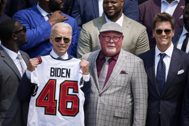 U.S. President Joe Biden holds up a Buccaneers jersey while standing next to head coach Bruce Arians and quarterback Tom Brady as he welcomes the 2021 NFL Super Bowl champions Tampa Bay Buccaneers during a ceremony on the South Lawn of the White House on