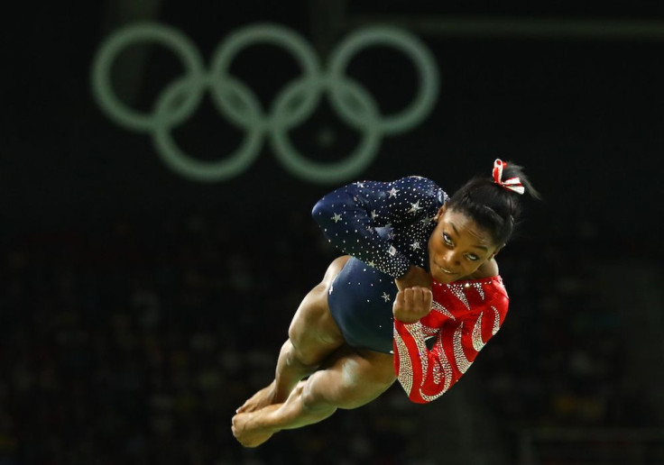 Simone Biles in a red and blue shiny leotard with Swarovski crystal embellishment 