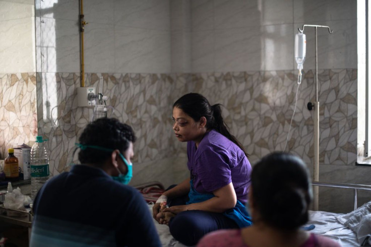 An Indian patient being treated for mucormycosis is tended to by relatives in a ward designated for those suffering from mucormycosis at the Sawai Man Singh Hospital