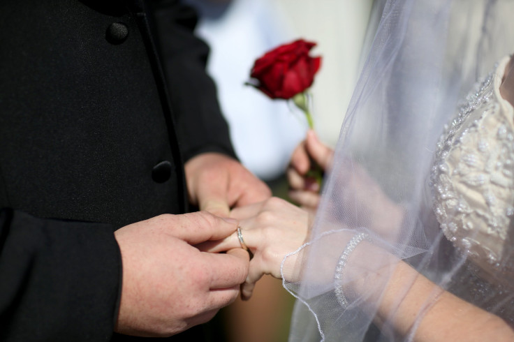 A couple exchanging rings, pictured February 14, 2014 in West Palm Beach, Florida, Universal Life Church is a business that allows people to obtain ordain credentials in a matter of minutes.