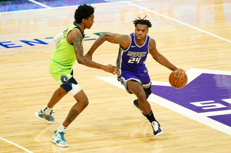 APRIL 20: Buddy Hield #24 of the Sacramento Kings handles the ball against Jaden McDaniels #3 of the Minnesota Timberwolves during the game at Golden 1 Center on April 20, 2021 in Sacramento, California.